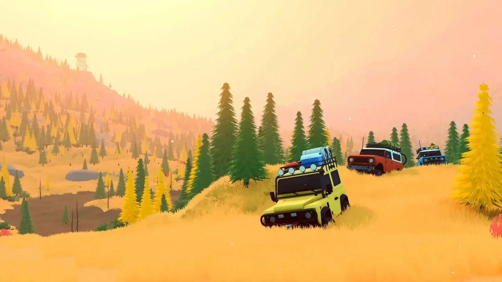 over the hill colorful offroad vehicles crossing a golden hillside among trees